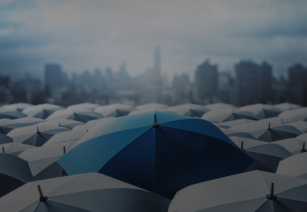 Image of blue umbrella surrounded by black umbrellas